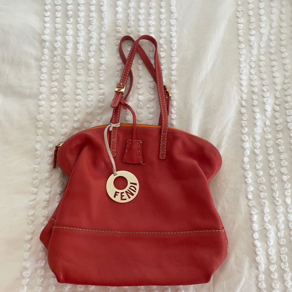 Orange leather shoulder bag.